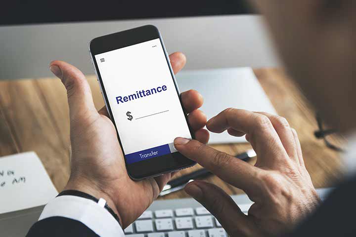 Man filling out digital remittance form on his phone